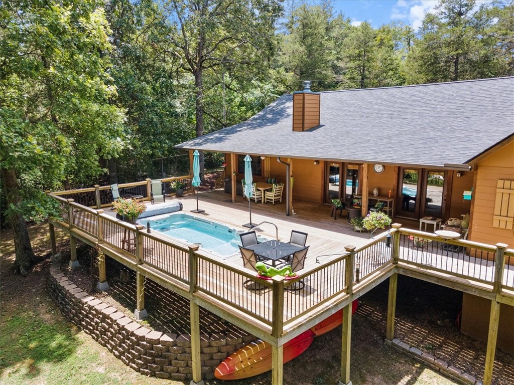 Escape to your own private paradise just outside of Eureka Springs with 3.5 acres on the White River. Unwind on the front porch and soak up the bounty of wildlife or enjoy a relaxing dip in your pool from the comfort of your large backyard deck. With over 250 feet of Army Corps preserved White River frontage you can even launch your kayak or canoe from your private trail leading right to the waters edge. This immaculately maintained home is move in ready with lots of recent upgrades including new flooring in all three bedrooms, hardwood in the primary and carpet in the guest room and home office. Upgrades also include a new roof, bathroom remodel, kitchen upgrades and fresh paint inside and out. This property has it all including a fenced side yard for your pets and a tall fenced in raised bed garden area. With 3.5 acres there is lots of space to spread out and enjoy alone time including meandering through the lovely stone labyrinth on your way to the sitting bench overlooking the river to watch the eagles fly by.