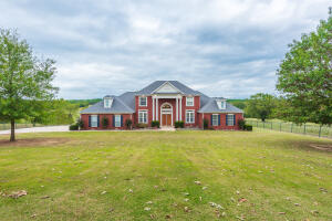 With Mount Magazine in the distance and 360 views of God's beauty from your 60+/- Acres of fenced and cross fenced pastureland, 2 barns, and 2 ponds this gorgeous stately home is at the centerpiece of it all. Boasting of quality throughout its 4000+/- sqft, let the majestic staircase start your journey and follow its features throughout. 4 bedrooms and 5 baths, formal dining room and an eat-in kitchen, office, and large master suite. With this amazing kitchen and family room, this home sets itself apart from the rest.