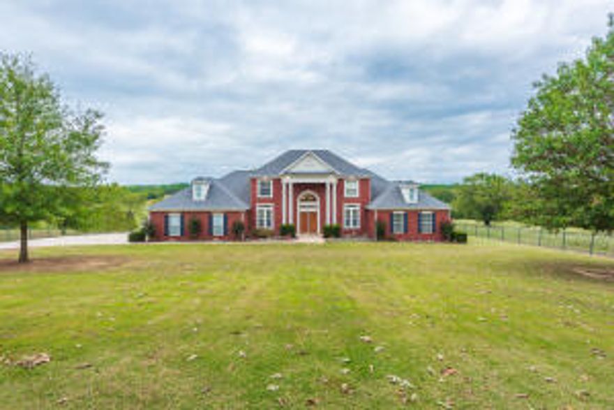 With Mount Magazine in the distance and 360 views of God's beauty from your 60+/- Acres of fenced and cross fenced pastureland, 2 barns, and 2 ponds this  gorgeous stately home is at the centerpiece of it all. Boasting of quality throughout its 4000+/- sqft, let the majestic staircase start your journey and follow its features throughout. 4 bedrooms and 5 baths, formal dining room and an eat-in kitchen, office, and large master suite. With this amazing kitchen and family room, this home sets itself apart from the rest.