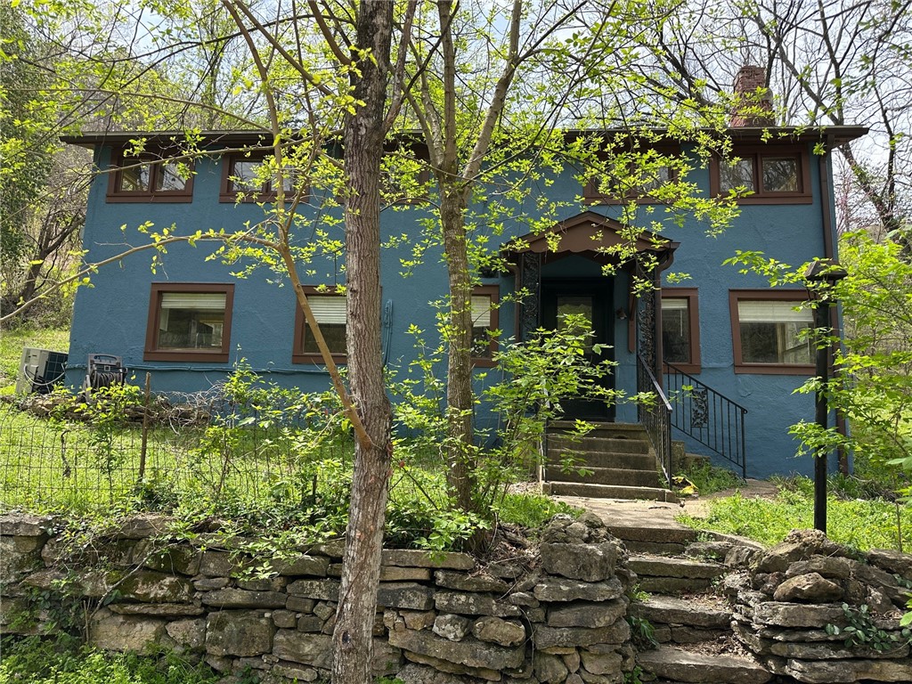 Quaint cottage nestled into historic Mill Hollow. This 2 story home features a large kitchen/dining/living area with stone lined cozy den on the first floor. Wide steps take you to the light-filled high ceilings of the second floor, with a large bathroom, 3 bedrooms and combo sunroom/mudroom/laundry leading to the very private backyard area bordered by woods. A good in-town rental property or starter home. Property zoning does not allow for nightly lodging rental. Sold As Is.