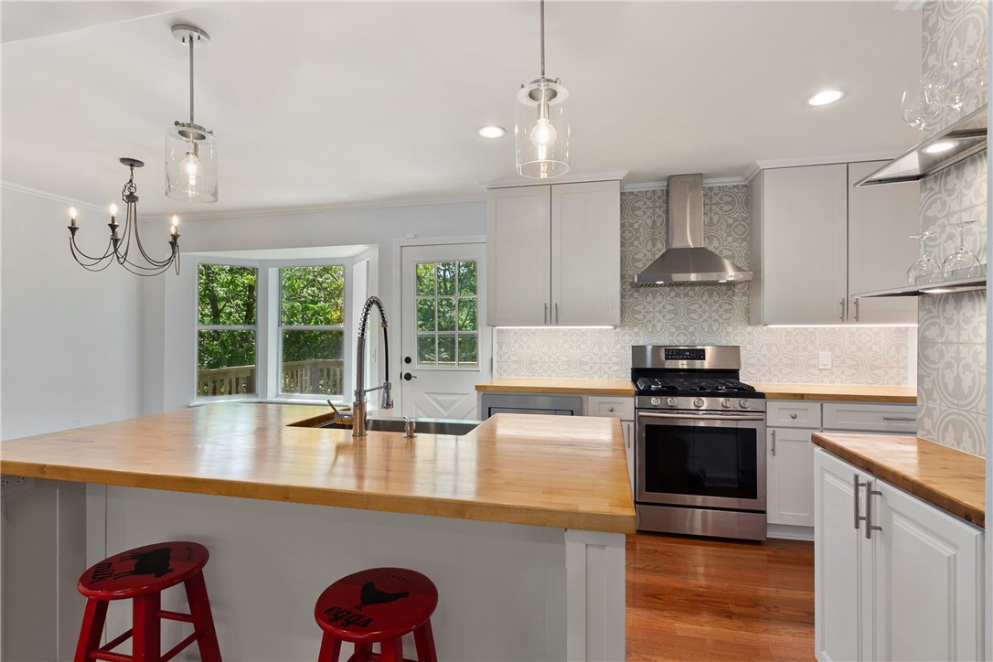 Tastefully remodeled three bedroom, two and half bath home with open concept and finished basement just down the road from Prairie Creek Park and Marina. Fireplace is vocal point of living room with beamed cathederal ceilings as well as built-ins and shelving flanked on both sides. Beautiful tree-top views from dining, kitchen and deck. Kitchen has been remodeled with new stainless steel appliances and designer back splash. Walk-out basement is open with beautifully remodeled half bath.