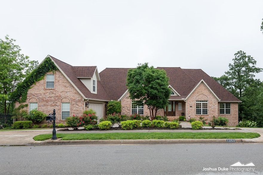 Unassuming East Fayetteville home w/east views for miles! Main home is 6,785 sq ft and includes 5 bedrooms, 3 full & 2 half baths, gourmet kitchen, living, frml dining, office, game room, media room, full theater, full bar. Guest house has 1,660 sq ft and includes 1 bedroom, 2 baths, living, full kitchen, and walk-in sauna. Newly refinished Walnut hardwood floors throughout. In-ground gunite pool. Home sits on 2 lots in Fay city limits. Full wrought iron fencing with privacy gate. Media room w/ theater chairs seats 10.  Zoned for Root Elementary.