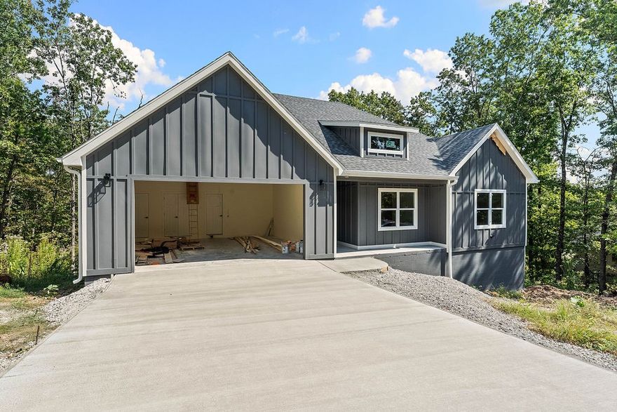 Welcome to this brand new custom home on a big flatish Bella Vista lot in a cul-de-sac close to Lake Ann and several bike trails. Open your new front door and you're welcomed by luxury vinyl plank flooring throughout entire home. The big living room has plenty of room for entertaining and a back wall of windows beaming lots of natural light throughout. Open style kitchen has beautiful quartz counters and a quartz island, gorgeous cabinets and stainless appliances with a stove/microwave combo and commercial grade stainless hood. The huge pantry will hold all your snacks and kitchen appliances with ease. A large laundry room with mud area and powder bath are around the corner. The big primary bedroom has an ensuite with dual vanities, soaker tub, custom tile shower and walk-in-closet. Two more bedrooms, each features large closets and big windows. A large covered deck out back overlooks lots of trees for privacy and the crawl space could easily be a workshop. Oversized garage and floored attic provide lots of storage
