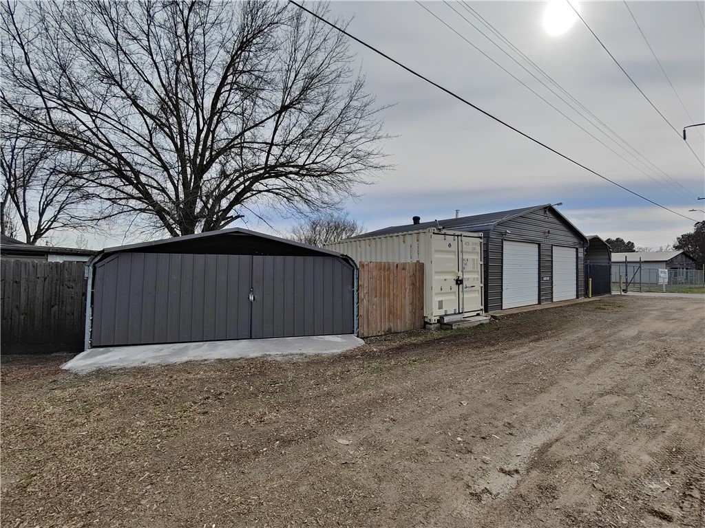This is 1 of 2 commercial lots that can be purchased together or separately. Tract 1 includes a large 30x30 shop and multiple storage facilities.