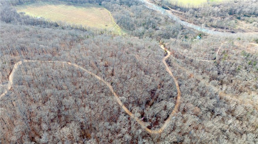 If you’re looking for a spot in the Ozarks with elbow room, privacy, and electricity on site, this 10 +/- acre tract in River Meadows deserves a look. With private road access, it offers gentle, usable terrain that makes planning a homesite easier than most mountain properties while still keeping the rugged Ozark character. The property has west-facing views, perfect for watching the sun set over the mountains. 

Owners also enjoy access to the 22 +/- acre community recreation area along the White River, with over half a mile of river frontage, cleared spots, and trails leading to fishing holes, swimming areas, or your favorite spots to relax. Conveniently located near the Pig Trail Bypass Café, Combs Store, Mill Creek OHV Trailhead, scenic hikes, and the Ozark National Forest, and just 20 minutes to Elkins and 30 to Fayetteville.