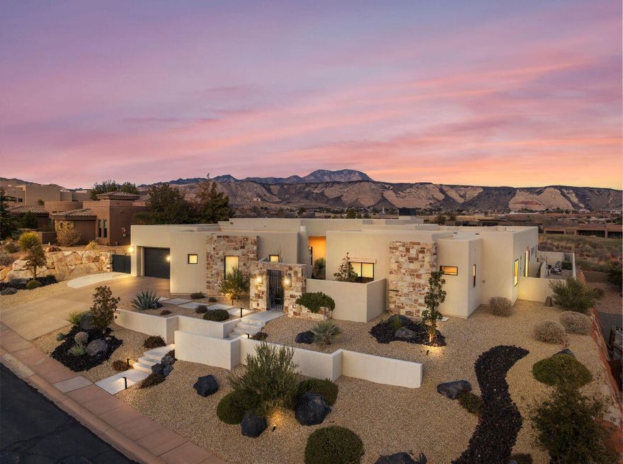 Behind the private gates of The Ledges, this custom home was designed with both tranquility and views in mind. A serene courtyard entry sets the stage for seamless indoor-outdoor living. Perched on an elevated lot, the residence showcases striking red rock panoramas, brilliant sunrises and moonrises, and offers shaded afternoons on the patio beside a dramatic lava rock waterfall. Inside the design is refined yet comfortable.A spacious primary wing creates a retreat of its own, while Restoration Hardware lighting highlights the clean lines and elevated finishes throughout.Vaulted ceilings, expansive windows, and a open layout bring in natural light and frame the desert landscape from every room. Every detail of this home has been thoughtfully curated, creating a one-of-a-kind opportunity to own a true showcase property in The Ledges.