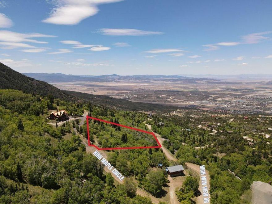 Enjoy panoramic valley and mountain views from this 1.23-acre lot in the Cedar Highlands. Located just 20 minutes from Cedar City and less than an hour to Brian Head Ski Resort and St. George, this property offers mountain living with convenient access to year-round recreation. The seller has already built a rough driveway at 2426 S High Maple Circle, providing a head start for future development. Depending on the orientation of your home or cabin, the address may also be 1006 E High Mountain View Dr. Cedar Highlands offers access to nearby National Forest and State Park lands, making it an ideal location for outdoor enthusiasts. Enjoy spectacular sunsets and frequent visits from local wildlife including deer, elk, and wild turkeys. Community well and power are available. Water is $35.00 a month. Buyer to verify connection requirements and lot details. Come walk the property and experience the setting firsthand - the views truly speak for themselves.