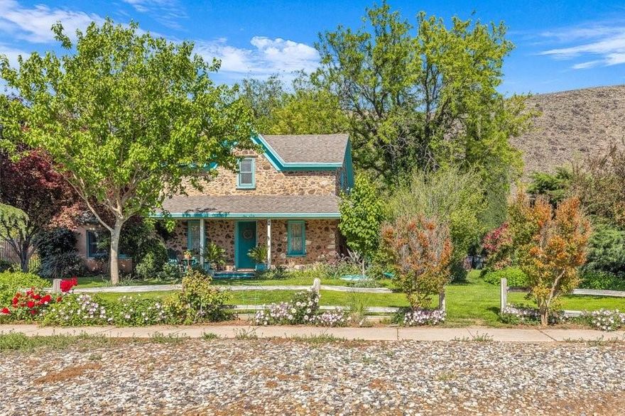 Charming and full of character, this beautiful stone pioneer home was originally built in 1874 and includes newer additions added in 1987, that seamlessly attach to the original home. The stucco living quarters have 2'' X 6'' construction that is packed with insulation.  The original basalt walls are 14'' thick.  The home is extremely quiet inside, and it does not need heating or cooling for 4 months of the year.  The original stone house served as a Presbyterian church & school for over 44 years.  It was later photographed by Ansel Adams & Dorothy Lange for a photo essay on ''3 Mormon Towns'' which appeared in Life Magazine, on September 6, 1954.  The house is surrounded by manicured flower gardens and beautiful, mature trees.  The gardens are automatically watered by a pressurized irrigation system available three days a week.  A large, covered patio is ideal for outdoor living and entertaining.  The house was re-shingled with premium asphalt shingles in 2018. A new Lennox heating & central air conditioning system was added in 2021.  The entire inside plumbing system was updated in 2025. Buyer to verify all information, deemed reliable, however buyer to verify all info including utilities, rental restrictions, and HOA information if applicable.
