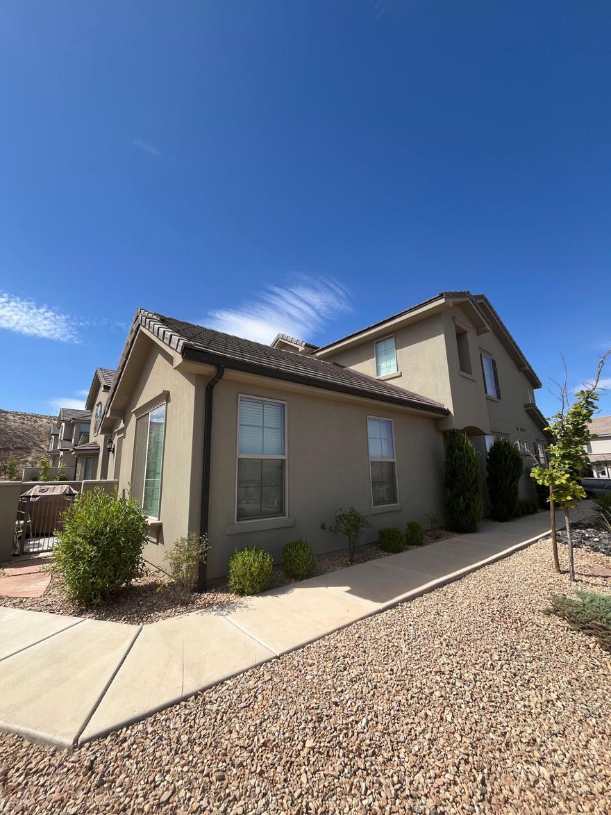 FULLY FURNISHED move-in-ready end-unit townhome with main floor master. This home has been well cared for and is in pristine condition. Home has a coveted 3.5 baths & all bedrooms are ensuite with their own FULL bath! Vaulted ceilings in great room. Elegant kitchen has both a warm feel & modern design. Upgraded storage cabinets in the garage! Family room gazes out onto a LARGE section of beautifully landscaped common area, which gives the residence more privacy than neighboring homes! Unit has excellent orientation, helping it stay cool in the summers! HOA includes all exterior yardwork, access to community pool, hot tub, & lounge area. Nearby Hidden Valley Park is one of the top parks in St George w/ a splashpad, massive playground, tennis, volleyball,. OWNER AGENT