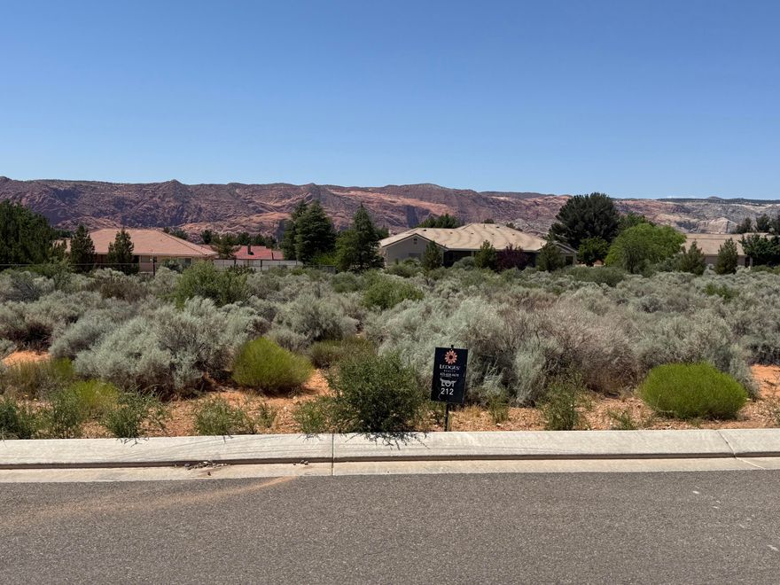 This property offers breathtaking views of the vibrant Snow Canyon State park red rock, providing a picturesque backdrop for your dream home. This 0.70 acre lot is able to use any builder, with low HOA fees.