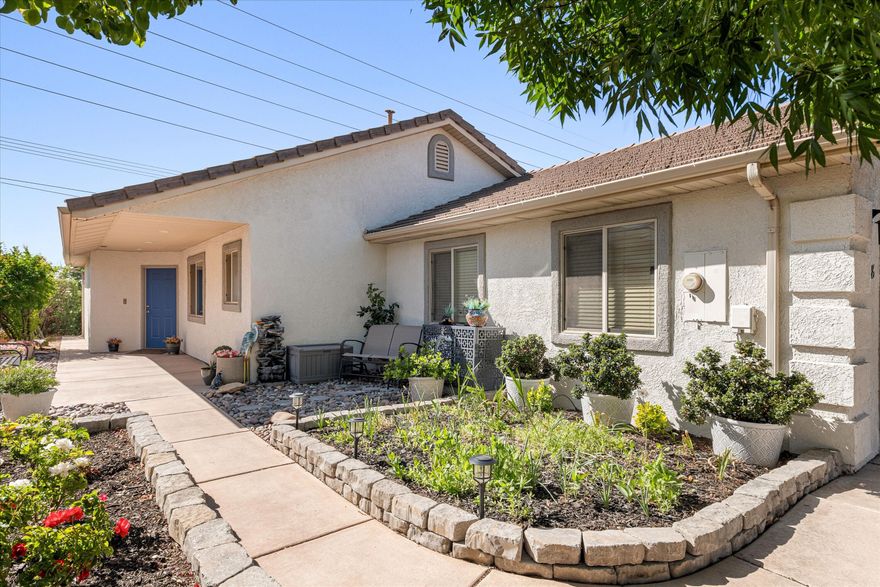 Welcome to a friendly, safe 55+ community with incredibly low HOA dues--where comfort, convenience, and pride of ownership truly shine. This standout property boasts the most beautiful home and yard in the neighborhood, offering exceptional curb appeal and a serene, private setting.

Ideally located just minutes from shopping, dining, and medical facilities, this home combines peaceful living with everyday convenience. Inside, you'll find a thoughtfully updated interior featuring new flooring, stylish countertops, and a charming farmhouse kitchen sink. The kitchen is bright and inviting, with ample cabinet space, abundant natural light, and picturesque views of the valley and nearby temple to the south. New appliances--including a dishwasher, stove, and microwave--make it move-in ready.

Additional upgrades include a new water softening system, disposal, water filtration system, ADA-compliant shower and toilet, and a new automatic yard watering system. The washer and dryer are also included for added convenience.

Step outside to enjoy a spacious covered patio--perfect for relaxing or entertaining--along with a private backyard that enhances the home's peaceful atmosphere. This is truly a rare opportunity to own one of the finest homes in a welcoming, well-maintained community.