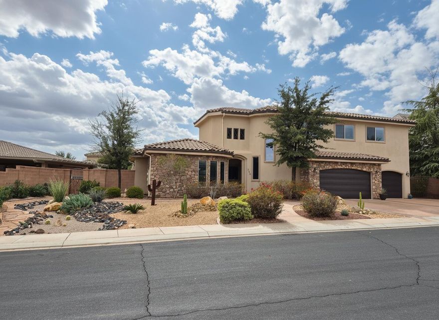 Located in a quiet circle in Santa Clara, this beautiful southwest home is full of wonderful features.  New carpet, 10' ceilings and oversized crown mouldings give this home a true luxury feel.  The kitchen is well equipped with all custom cherry cabinetry and a grand center island for all to gather around.  The oversized pantry is concealed by a hidden door and contains a secret staircase which leads up to an amazing bonus loft.  The bonus loft with it's own half bath sits above the 3 car garage and offers endless possibilities for flex space.  This area can also be accessed by an amazingly crafted spiral staircase which showcases the front of the home.  The primary suite is oversized and contains a double sided fireplace and it's own private den.  Soak in your jetted tub or enjoy the double spray walk in shower.  The closet has his and her wings with ample space, a makeup counter and built in organization.  Lastly, dual sinks and plenty of storage.  A private pool adorns the side patio and the indoor/outdoor cabana bar is perfect for those days where everybody is over to cool off in your oasis.  The pool has been newly tiled and plastered in a rich blue and has its own sandstone diving rock.  Other pool area features include a fully retractable cover, pool heater, outdoor shower, and outdoor access to a half bath making this area simple and easy to enjoy.  Behind the home down a private lane is a bonus 2 car shop with it's own half bath.  Come tour this home and make it yours today!  Owner Agent. The primary suite is grand with its own private den, fireplace and outdoor access.  Tons of storage throughout.  Well maintained with all new carpet throughout, new gutters, new pool heater within the last 6mo.  Pool was completely replastered and new tile in 2023.  Owner Agent.