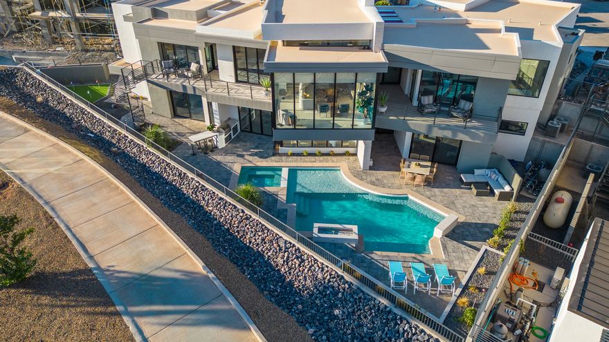 The Luxe at Copper Rock is more than a home—it's an opportunity. Perfect as a nightly rental income property, a corporate retreat, or a family vacation escape, this residence is designed to deliver both lifestyle and investment potential. Walls of glass and open-concept living spaces blur the line between indoors and out, drawing in golf course and red rock views at every turn. The gourmet kitchen flows effortlessly to expansive dining and living areas, while bedroom suites provide spa-inspired retreats with private patios. Step outside to a private resort-style oasis featuring a sparkling pool, covered lounge areas, and plenty of room for entertaining. Whether hosting a gathering or relaxing with family, the design centers around seamless indoor/outdoor living. Set within the prestigious Copper Rock Golf Course community, you'll be minutes from Sand Hollow Reservoir, Zion National Park, and endless trails for boating, hiking, and off-road adventure. The Luxe at Copper Rock combines modern sophistication with adventure-driven livingan investment and retreat unlike any other.