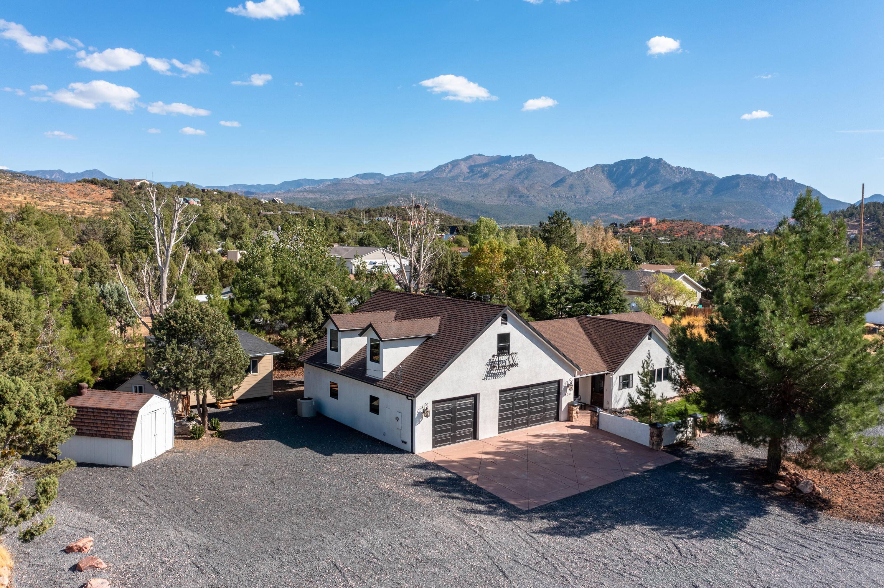 Welcome to this beautiful mountain home just far enough out of town to escape the hustle and bustle, yet close enough to all the conveniences you need, with year-round access. This well-cared-for and updated property sits on a spacious corner lot, offering a fully landscaped yard for you to enjoy, plus a 20x15 shed and a 3-car attached garage and RV parking, providing ample storage and parking space for all your needs. The home itself offers plenty of mature shade trees and pleasant courtyard patios. Inside the home is brightly lit from the many windows, with LVP flooring, granite countertops and built-in appliances. Enjoy direct access from the property to the Dixie National Forest for thrilling off road adventures. No HOA and in a fantastic community with great people.