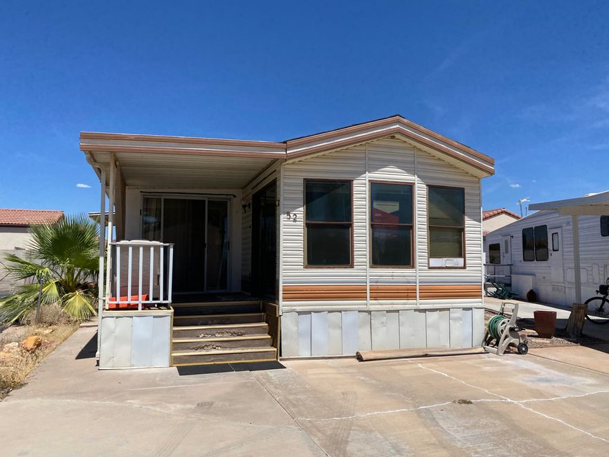 SELLERS ARE FIRM ON PRICE. There is parking in front and on the side of the home. 55+ Community. This home is priced appropriately for the condition. Needs TLC. Home is being sold as is. Refrigerator not included. Home appears to have an add-on which may not be included in the SF. Sellers claim the propane tank is full. The home needs these repairs:
  
Roof where the swamp cooler is needs to be repaired. 
Water damage repair inside the home from the swamp cooler
A heat pump needs to be added to the home.
Home need paint inside and out
Home needs new carpet inside 
Home needs outdoor carpet on the porch
Home needs to be cleaned
Please note: There may be more repairs required that I'm not aware of.