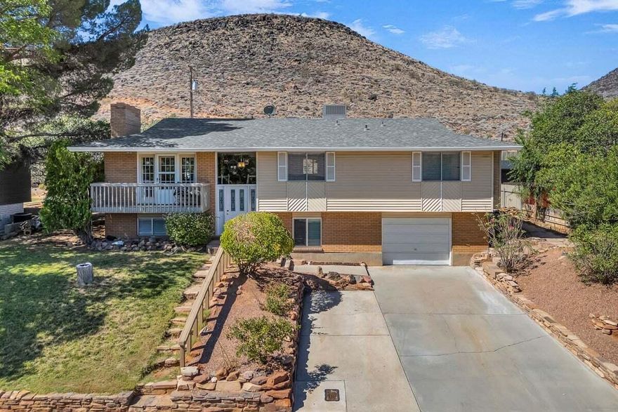 This beautifully updated home offers a fresh, modern feel with an upgraded kitchen and thoughtful improvements throughout. Located in a highly sought-after, quiet neighborhood perched above downtown, it showcases incredible views of St. George city lights and the surrounding red rocks. The layout provides tons of space with two basements, creating endless possibilities for living, entertaining, or storage. The large private backyard is a blank canvas that backs directly to the D Hill, offering access to multiple trails and no rear neighbors. Recent upgrades include a new A/C with added insulation, a new water heater and softener, and a newer roof for peace of mind. With its unbeatable location just minutes from Tech Ridge, downtown, shopping, and hiking, this home also offers one of the best spots to enjoy fireworks and local celebrations. Buyer to verify all information, deemed reliable, however buyer to verify all info including utilities, rental restrictions, and HOA information if applicable.