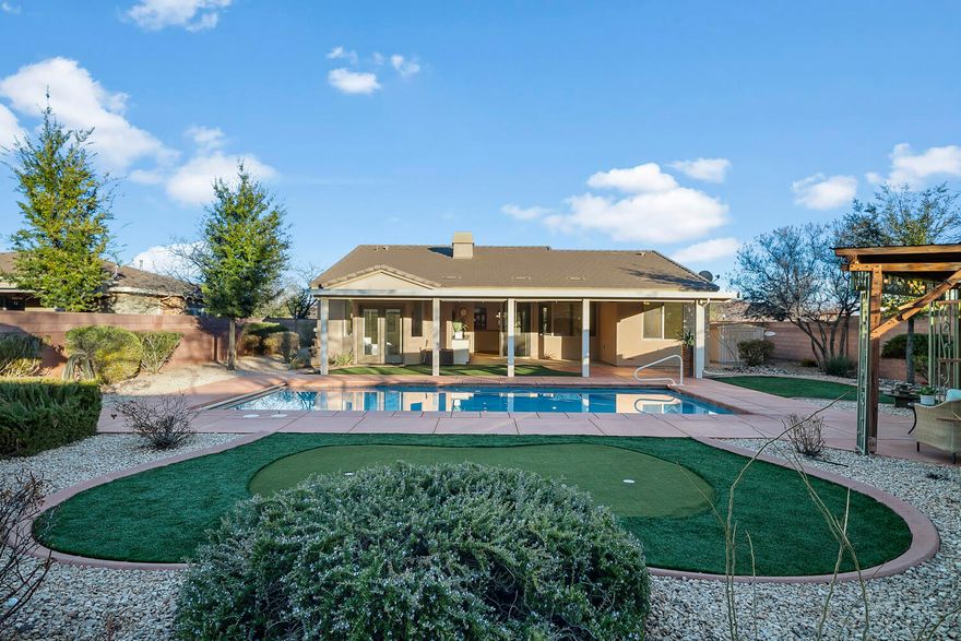 Welcome to your private desert oasis in the highly desirable Coral Canyon community! This stunning home is located on a corner lot on a dead-end street, guaranteeing a quiet neighborhood feel.  This beautifully maintained 1,917 sq ft home offers 3 bedrooms, 2 baths, plus a front office/flex room—ideal for working from home or creating a versatile retreat. Situated on an expansive .32-acre lot with mountain views, the outdoor space is truly exceptional. Enjoy resort-style living with a stunning heated private in-ground pool, tranquil water feature, putting green, large covered deck, two pergolas, gazebo, and lush, mature landscaping—with multiple trees that provide abundant shade and privacy. The home boasts outstanding indoor/outdoor flow with an impressive 8-foot-wide slider that opens to a huge covered back patio, perfect for entertaining or relaxing year-round. The thoughtfully designed split floorplan provides added privacy for the primary suite, which offers direct access to the backyard oasis - wake up to soothing water sounds and pure serenity. The spa-like primary bathroom features dual shower heads, double vanity, and high-end custom closet cabinetry and organizers - a closet you'll absolutely love!
Additional highlights include custom built-ins throughout the house, custom window coverings, a cozy fireplace, stainless steel appliances, gas drop for a barbecue, and quality finishes in this beloved home. The two-car garage extra deep and is equipped with tons of storage.  The pool heater allows you to extend the swimming season well into late fall and winter. HOA is just $85/month and includes access to a workout room, tennis courts, pickleball, and pools.
This Coral Canyon gem delivers the perfect blend of comfort, luxury, and lifestyle - an incredible opportunity you won't want to miss!  All information is deemed reliable but not guaranteed, buyer to verify all.
No showings until the open house on 1/24/26 from 11AM - 3PM.