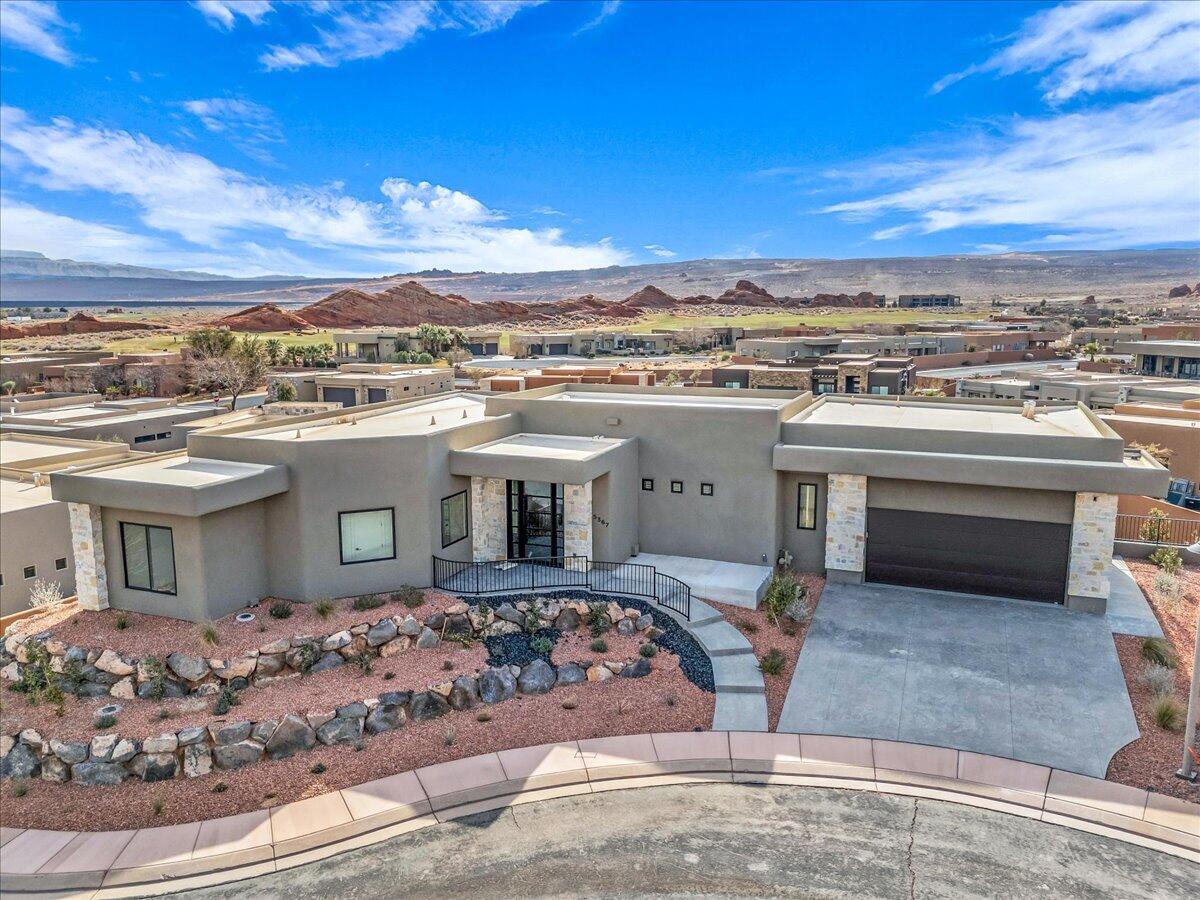 Nestled in Southern Utah's premier golf course community of Sand Hollow. This stunning 4 bedroom, 5 bathroom residence boasts breathtaking views and exudes luxury living! The expansive living room features floor to ceiling fireplace that seamlessly flows in the gourmet kitchen, complete with a spacious island, quartz countertops, high end appliances and abundance of storage. The walk out basement includes an additional family room, perfect for entertaining. Throughout the property, meticulous attention to detail is evident in the high end finishes, creating a sophisticated ambiance. The fully landscaped backyard provides a serene oasis with large deck for taking in the views. HOA amenities include  access to community pools, pickleball courts as well as yard care. Conveniently located just minutes from Sand Hollow State Park, sand dunes and multiple golf courses