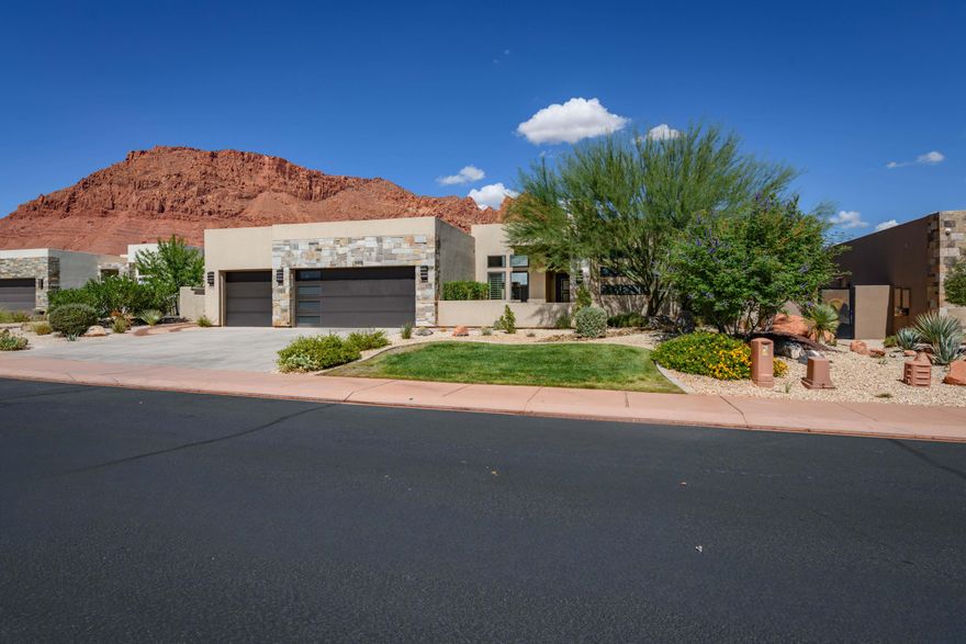 Located at the base of the iconic red cliffs of Ivins, this single-level home offers modern design and function. The 2,524 sq. ft. main home plus 339 sq. ft. detached casita create a layout ideal for both everyday living and hosting. The great room and kitchen flow into a split floor plan, with the primary suite privately set apart. Two guest bedrooms and a bath sit on the opposite side for added privacy. The detached casita provides flexible space for guests or an office. On .34 acres, the yard offers room to add a pool. Resort-style amenities at The Palisades include multiple pickleball courts, tennis, basketball, clubhouse, fitness center, large pool, hot tub, and outdoor kitchen—all in a secure gated setting minutes from Snow Canyon & Tuacahn.