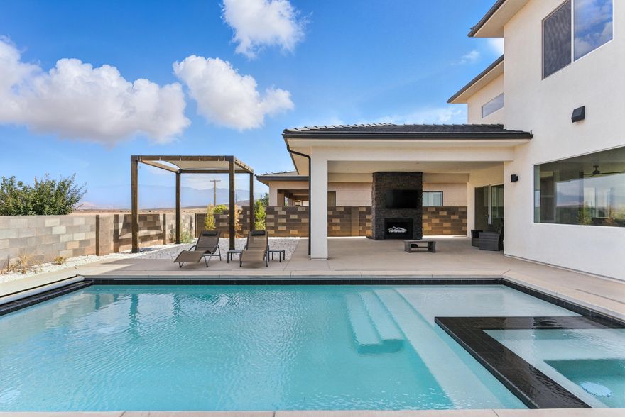 You've found it!  A wonderful 5 bed 4.5 bath home with pool and views plus a huge 900+ square foot garage.   High-end finished, lovely interior decor, thoughtfully functional floorplan for an active family or empty nesters that want room for all their guests.  Entertain in style w/ez of flow from in to out of doors though walls of opening glass to the large covered patio w/fireplace and the adjacent pool.   IN HOUSE FINANCING OPTION