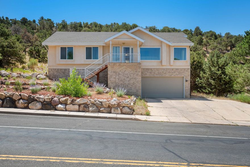 Discover serenity and space in this picturesque 4 bedroom 2 bathroom home boasting panoramic views of the valley. Nestled on a large lot, this residence offers both comfort and convenience with recent upgrades including new windows and a roof installed in 2019. Step inside to find a top-level open floor plan that invites natural light to every corner. For added versatility, the lower level includes a 2 car garage and a bonus room, perfect for a home office, gym, or 4th Bedroom. Outside, the property is complemented by a tranquil setting, backed up to a wooded hill ensuring privacy and a connection to nature.