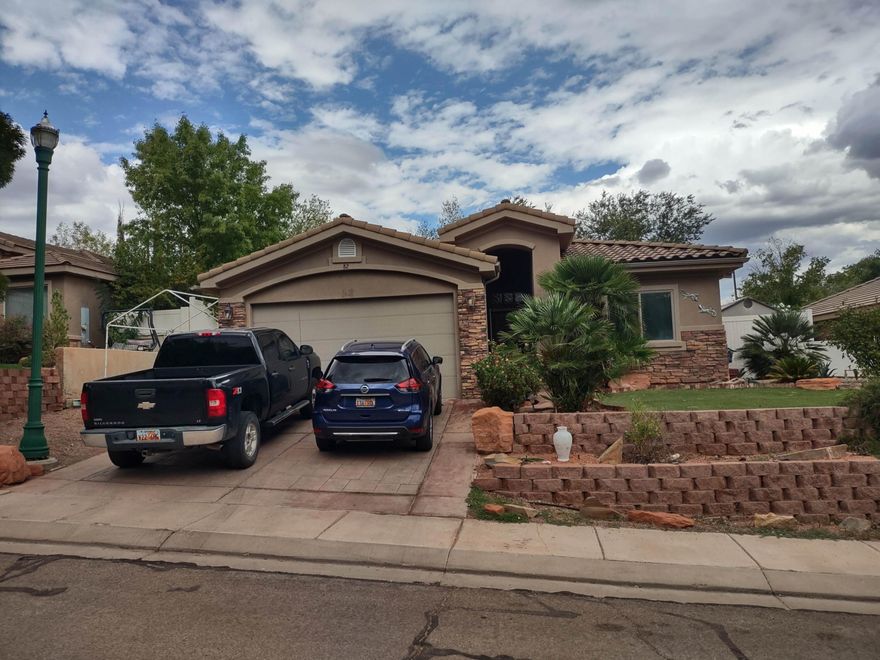 Stunning model home in the Beautiful Hurricane Community. Premium upgrades include custom cabinets with roll-out shelves, granite counters, travertine tile, transom windows, coffered living room ceiling, and fans in the great room and bedrooms. Beautifully landscaped front and back yards, fenced on three sides.