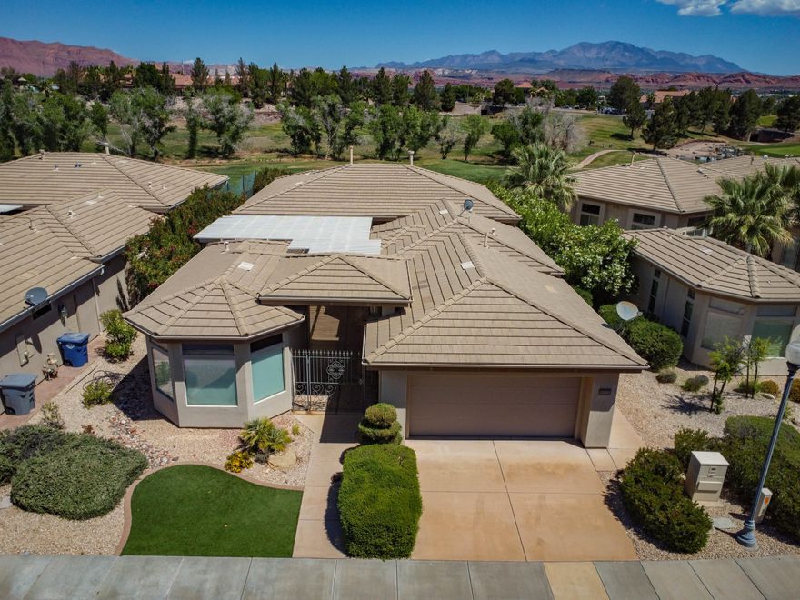 This gently lived-in second home offers 4 bedrooms and 4 bathrooms, ideally positioned on the 9th fairway of the Woodbridge course in Sunbrook. Enjoy sweeping, unobstructed views of Pine Mountain, Snow Canyon, and Red Mountain from the comfort of your own home. 
Designed for both comfort and elegance, the property features 12-foot ceilings, 8-foot doors, and expansive Low-E butted glass windows in the dining room, living room, and primary suite-filling the space with natural light while showcasing the stunning surroundings. Outdoor living is equally inviting, with a fully covered courtyard complete with an awning and built-in grill, as well as a spacious covered back patio perfect for relaxing or entertaining. The kitchen is appointed with stainless steel appliances, and the garage is thoughtfully equipped with epoxy flooring, ample storage cabinetry, and bike racks. This is a rare opportunity to own a beautifully maintained home in one of Sunbrook's most desirable golf course settings.