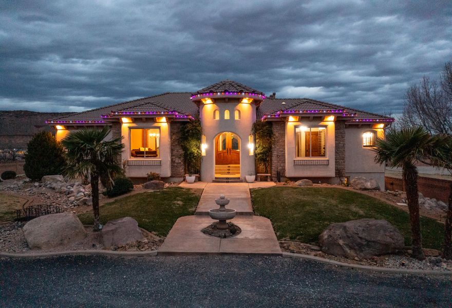 Your very own PRIVATE Virgin River Equestrian Estate on 2 ACRES with all your DREAM FEATURES, stunning VIEWS and the ultimate OUTDOOR LIVING. This fine LUXURY CRAFTED home is finished with engineered hardwood and travertine flooring throughout. The Main WALK-OUT BASEMENT Home is 5,800 sq. ft. w/ 6 bedrooms, 4 full bathrooms, & 2 half bathrooms & 2 large gathering areas. The Primary Owner Suite is on the MAIN LEVEL and the 2nd OWNER SUITE is in the basement. The spacious kitchen has 2 COPPER SINKS, Built-in APPLIANCES and GIANT HIDDEN PANTRY. The basement has a FULL 2nd KITCHEN, private THEATER with all the equipment, a 2nd LAUNDRY Room & several storage rooms. The detached GUEST QUARTERS / ADU is 600+ Sq. Ft. and comes with 1 Bedroom, 1 Bathroom, laundry area and full kitchen. The RV GARAGE is insulated with a mini-split system and includes a car lift.  Total garage space is 2305 Sq. Ft., so tons of parking for cars, trailers and toys.  This estate is ideal for hobby farm and very animal friendly w/  horse corrals, tack shed, and pastor w/ access to the Virgin River.  The BACKYARD OASIS includes a pristine SWIMMING POOL, hot tub, playground, full bathroom and BUILT-IN BBQ. 3,000 sq. ft. of COVERED PATIO space for beautiful views of Pinevalley Mountain, Virgin River and the Red Rock Candy Cliffs.