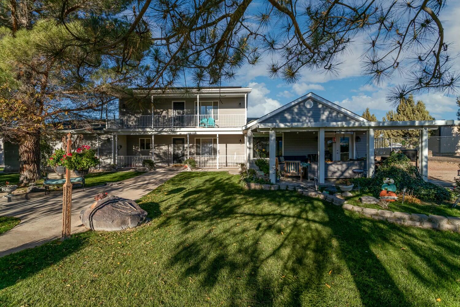 Discover the perfect blend of country charm and modern convenience on this stunning 1-acre property with breathtaking views of Pine Mountain! This beautiful home boasts two master suites, including an expansive second-level suite with a covered deck to relax and soak in the scenery. The spacious kitchen and dining area feature updated appliances and a convenient pantry. Highlights include a cozy family room, craft room, greenhouse, RV parking with hookups, a detached garage with a workshop, ample storage, solar panels, and a brand-new roof. Don't miss this exceptional opportunity to own a truly unique property!