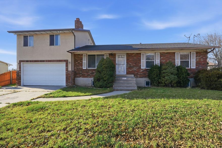 This well maintained home offers comfortable living in a convenient location. Situated next to Elementary school and just a few minutes from shopping, dining and everyday amenities. The updated kitchen includes custom cabinetry, modern finishes and flows seamlessly into the main living areas. The basement includes a second family room complete with a wood burning fireplace, bedroom, bath and storage room. Outdoors, enjoy a fully fenced backyard with room to relax, play or garden along with a covered deck ideal for outdoor entertaining. Plenty of room for parking in the 2 car garage plus a covered carport in the back. Mountain views add a scenic backdrop.