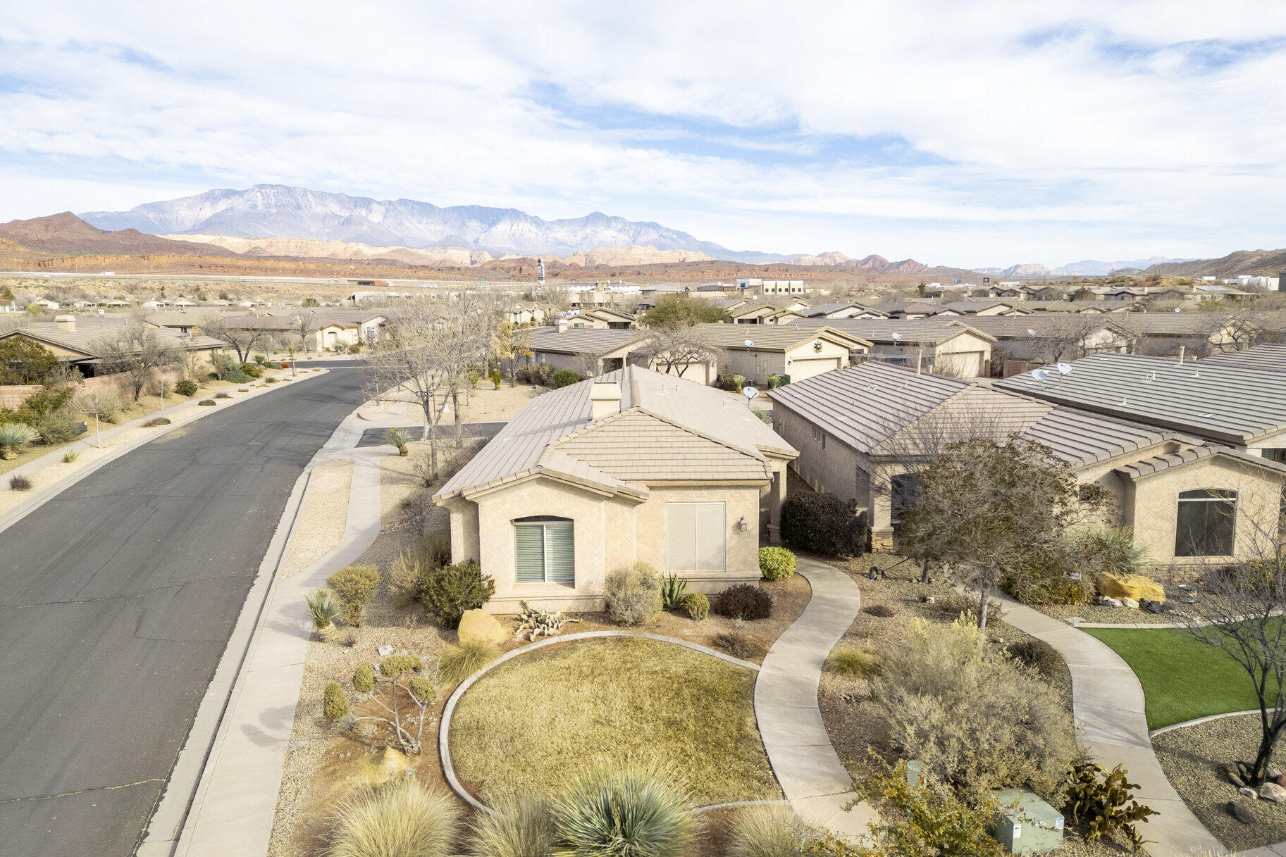 Nestled in the sought-after Coral Canyon neighborhood, this charming and cozy home offers mountain and golf course views. As you step inside, you're greeted by a warm and inviting living space with an abundance of natural light pouring through large windows, perfectly framing the stunning scenery outside. The open-concept design creates a seamless flow between the living room, dining area, and kitchen ideal for both relaxing and entertaining. The kitchen features plenty of counter space, and a cozy breakfast nook where you can enjoy your morning coffee while soaking in the views. A corner location provides both privacy and views. With two comfortable bedrooms, an office, and two spacious bathrooms, this home provides a peaceful retreat after a day of outdoor adventures or rounds of golf With its prime location, this home offers the best of both worlds -- peaceful, nature-filled surroundings and easy access to golf, hiking, and all the amenities St. George has to offer. The extended garage gives you plenty of room for parking with extra space for a small workshop. Whether you make this a second home or your permanent one, you will fall in love with the community and the ease of access. Don't miss out on the chance to own this cozy gem in a picturesque setting!