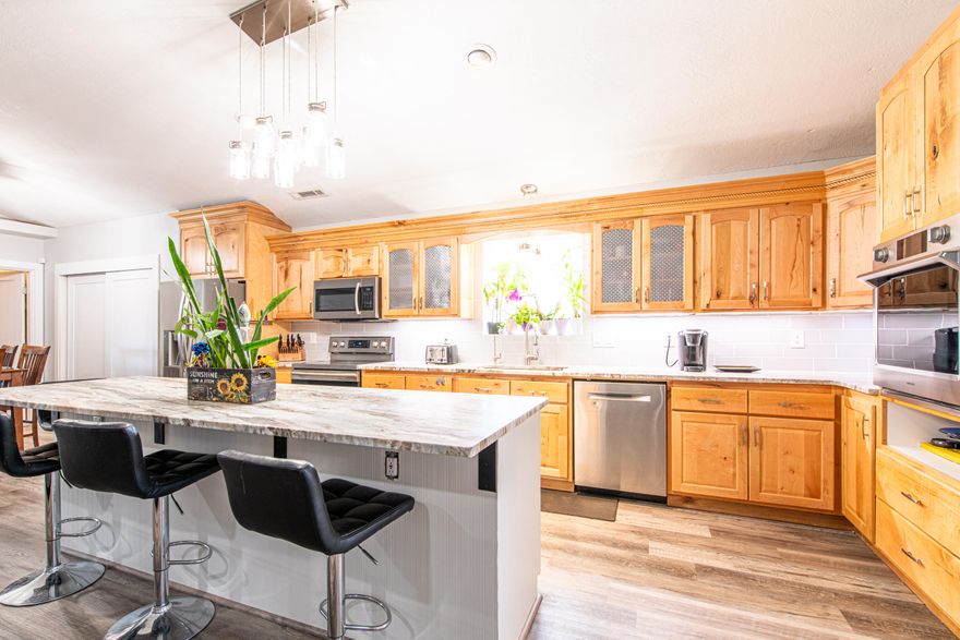 Welcome to this stunning 3,887 sq. ft. estate on .94 acres of beautifully landscaped land, offering the perfect blend of luxury, comfort, and functionality. With 5 bedrooms, 4.5 baths, a main-floor primary suite, second main floor suite, updated kitchen, flooring, bathrooms, new windows and sliding doors this home is designed for both everyday living and entertaining.  Zoned R-1, Horses are permitted, irrigation water, RV Garage, plus additional RV parking with hookups, pool, hot tub, 2 full outdoor bathrooms, Large garden area with raised boxes. Square footage figures are provided as a courtesy  Buyer is advised to obtain an independent measurement.