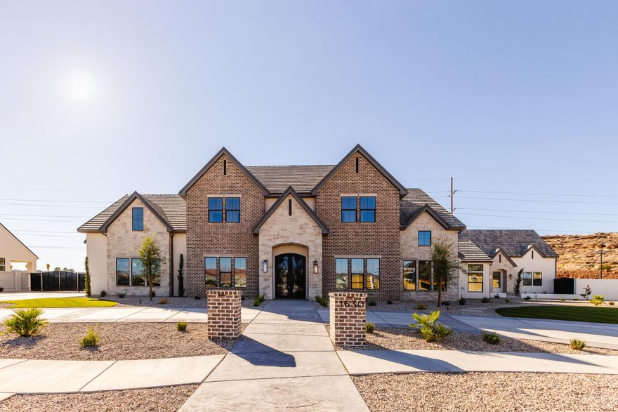 Located in the new luxury subdivision ''The Grove'' with stunning Pine Valley Mountain views, this luxury estate showcases a private pickleball court, 20x40 pool and hot tub, and a detached 1,500 sqft casita with 3 bedrooms and 2 bathrooms. The home spans over 8,000 sqft with 9 bedrooms and 10 bathrooms, featuring a chef's kitchen with Wolf and Sub-Zero appliances, a spa-inspired primary suite with heated floors and steam shower, exposed wood beams, designer finishes, private office, mirrored home gym, and an oversized boat garage. Set on a rare ¾-acre lot, this property offers tons of space, recreation, and a one-of-a-kind lifestyle in one of Southern Utah's most desirable locations.