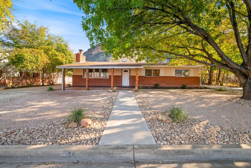 Discover classic country living in this charming rambler ranch-style home in downtown Hurricane. Set on a generous 0.50-acre & zoned for horse property, this 3-bed, 2-bath home offers a warm, inviting feel with a wood-burning stove and plenty of room to spread out. Enjoy RV parking, peaceful mountainside views from the backyard, and functional outdoor amenities including corrals, a garden spot, a storage shed with a small workshop, and a fruit cellar. A rare blend of convenience, character, and true rural comfort-tucked away, right in the heart of town. 
**There is also secondary Irrigation water available and pressurized to this property for a small fee to the city each month.