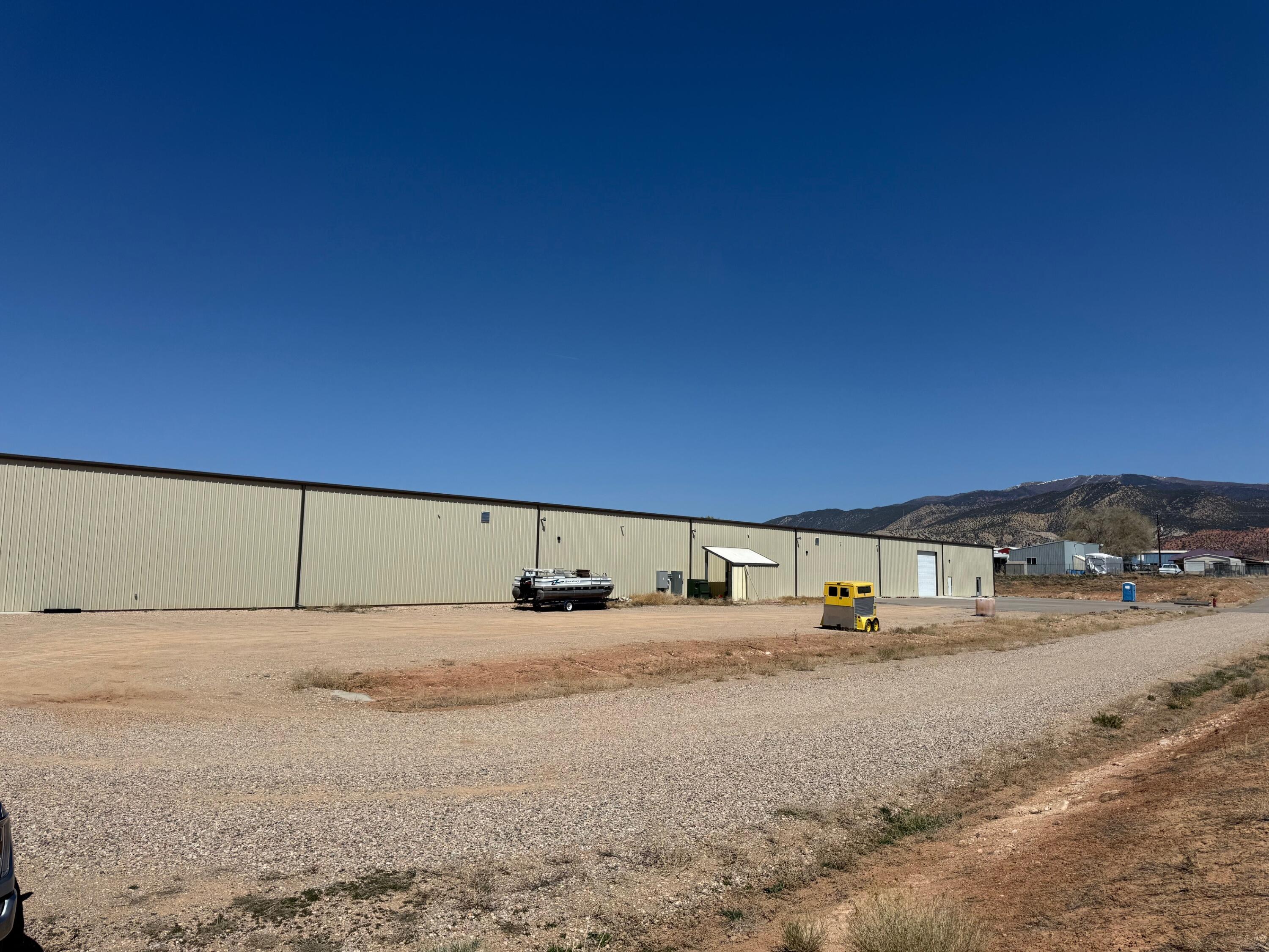 10.5 Acre parcel just off Airport Road, including a 40,000 square foot building that was built in 2023. There are 4 overhead drive through doors that line up for drive through access. It also has 1 bathroom plus 2 more that are roughed in. Several office and conference and storage rooms that are 70% finished. Heated and great lighting.