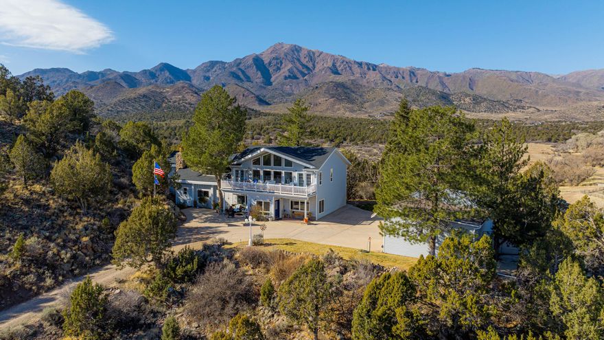 Located in the serene community of New Harmony Utah, Happy Trails 2 U Ranch is an easy drive to both St George and Cedar City Utah; two popular destinations in southern Utah with ample amenities, shopping and medical facilities. The home, barn and outbuildings are conveniently arranged around a camp-like setting in the middle of the 50 acres, providing an incredible spot for family reunions or visiting guests. The home is comfortable and inviting. Significant improvements having been made to the home and property over the years. A large second floor space serves as a mother-in-law suite, work-from-home office, or even an art studio. Views abound from the home with the front deck offering an incredible unobstructed line of sight to the Kolob Canyons "5 Fingers" rock formation. The home and property sit at approximately 5,000 feet in elevation and are bordered by Ash Creek to the west - this part of southern Utah offers warmer summer days, cooler evenings and milder winter weather. Happy Trails 2 U Ranch would serve as an ideal equestrian property.  With access to the Pine Valley Mountain Wilderness in your backyard, skiing at Brian Head resort and proximity to Zion National Park, there are no shortage of places to go and things to do.  Mountain biking, horseback riding, hiking, skiing, and ATV riding are all popular activities in this part of southern Utah. For access to world class shopping, dining and entertainment, Las Vegas is approximately 2 hours and 15 minutes down Interstate-15.  In addition to fenced pasture, the ranch includes a hay barn, a workshop and smaller barn set up with a chicken coop and walk-in cooler for meat processing and storage.  There is plenty of storage for equipment and vehicles on the ranch. Six RV pads each have clean-outs, plus power and water supply. The outdoor kitchen is a perfect amenity for entertaining friends and family, spring through fall. Three water rights on the ranch provide 5-acre feet of water for irrigation and livestock. Water to the ranch is sourced from a well and pumped to a large holding tank.