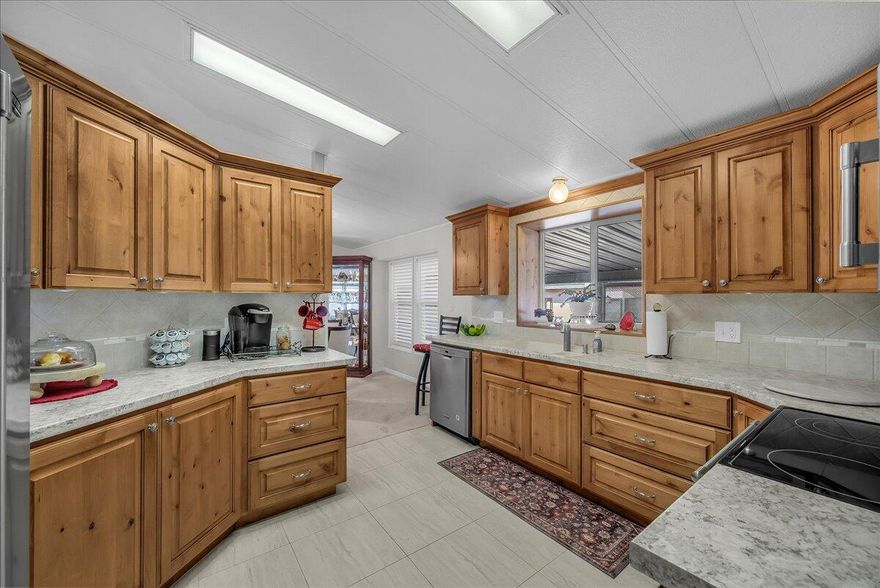 Experience the pinnacle of quiet adult living in this impeccably remodeled Rainbow Ridge home, where modern amenities meet affordability. Every inch of this 55+ sanctuary has been thoughtfully upgraded, featuring a new kitchen, an expansive family room, and a master suite designed for ultimate relaxation with its oversized walk-in shower and spacious closet. Freshly finished with new paint and carpet throughout, the home offers total peace of mind with practical additions like a new water heater and a dedicated laundry room with a utility sink. Outside, your private retreat awaits, complete with a hobbyist's shop, garden beds, and serene views. Coupled with great community amenities—including a pool, indoor hot tub, and fitness center—this home offers a turnkey lifestyle