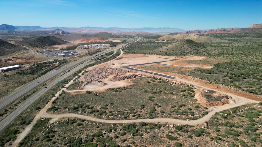 Prime ±17.8-acre development site zoned $16/SF Business & Manufacturing Park (BMP) just west of Exit 27 off I-15 in Toquerville. Excellent freeway access, strong visibility, and close to the new reservoir in a growing Southern Utah corridor. Zoning allows office, retail, hotels, gas stations, dining, coffee, storage, parking, small business, and light manufacturing--ideal for mixed-use or phased projects. Traffic, survey, archaeological, and geotech studies complete; grading permits in place. Utilities available; water lines installed. Horizontal improvements ~90% complete. Adjacent ±28 acres also available. Listing information deemed reliable; buyer to verify. Please call for details.