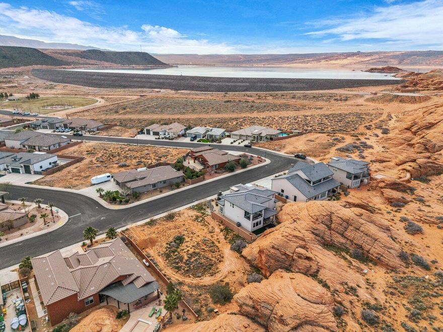 Don't miss the rare opportunity to own one of the last remaining lots backing directly to the breathtaking natural red rocks in Dixie Springs! Wake up to the beauty of Southern Utah's iconic red rock scenery right in your backyard on this spacious, flat lot with endless potential. Bring your own builder and create a custom home perfectly tailored to your vision, with no HOA restrictions. Utilities are conveniently available at the lot, including Dixie Power. Located just seconds from Sand Hollow Reservoir and the sand dunes, and only minutes from shopping, gas stations, and grocery stores, this location offers the ultimate blend of outdoor adventure and everyday convenience. Buyer to verify all information, deemed reliable, however buyer to verify all info including utilities, rental restrictions, and HOA information if applicable.