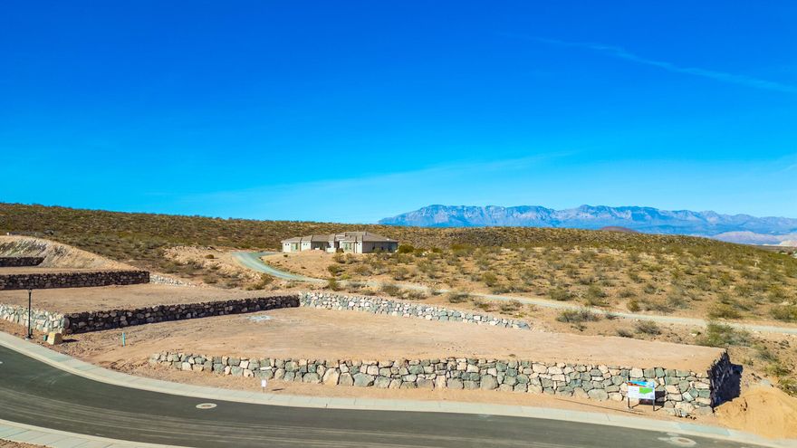 Discover The Views at Hurricane Cliffs — where modern living meets iconic Southern Utah scenery. These premium, oversized lots showcase sweeping panoramas of red rock cliffs, desert mesas, and wide-open skies. Tucked into a quiet elevated setting with direct access to world-class hiking, biking, golfing, and off-roading, yet only minutes from shopping, dining, and everyday conveniences — this community delivers the best of both adventure and comfort. Each homesite is strategically positioned to maximize privacy, views, and natural light, creating the perfect foundation to design and build your dream home. Buyers have the opportunity to work with an exclusive group of approved builders known for exceptional craftsmanship, custom design, and seamless build processes. These experienced builders are dedicated to creating homes that blend effortlessly with the landscape while capturing your personal style and vision. The Views at Hurricane Cliffs offers a rare chance to build in one of Southern Utah's most breathtaking and fast-growing areas. Come walk the lots, take in the scenery, and imagine your future home in this unforgettable setting.