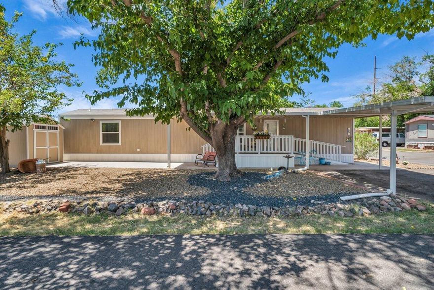 Welcome to this well-maintained 2 bed, 2 bath home in the desirable 55+ community of Pleasant View. This charming end unit is perfectly situated near the dog park, offering both privacy and convenience. Enjoy peaceful mornings on the large covered front deck, which includes a ramp for easy access. The home also features a covered carport for parking and a spacious shed for ample storage. With newer skirting and a prime location close to parks, trails, shopping, and more, this home offers comfort, convenience, and low-maintenance living! Buyer to verify all information, deemed reliable, however buyer to verify all info including utilities, rental restrictions, and HOA information if applicable.