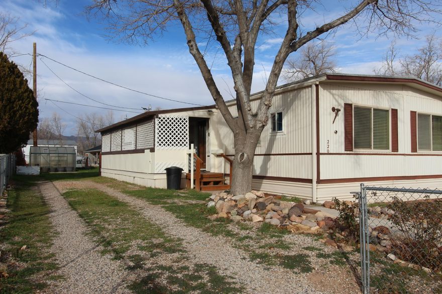 Tucked on an owned 0.14-acre lot, this double-wide manufactured home is in great shape and has been lovingly maintained. It comes fully loaded with all appliances, including the washer and dryer, so you can move in and start living, not shopping. Step outside to enjoy nice views, a fully fenced yard, oversized porches made for morning coffee and sunset wind-downs, plus RV parking and a detached two-car garage for all the toys, tools, and weekend plans.
Low utilities keep things practical, and the location keeps life easy, with amenities within walking distance. When you want to play, you're about 20 minutes from Springdale and Zion National Park, and around 20 minutes to Quail Creek and Sand Hollow State Parks. This one checks the boxes and brings the lifestyle.