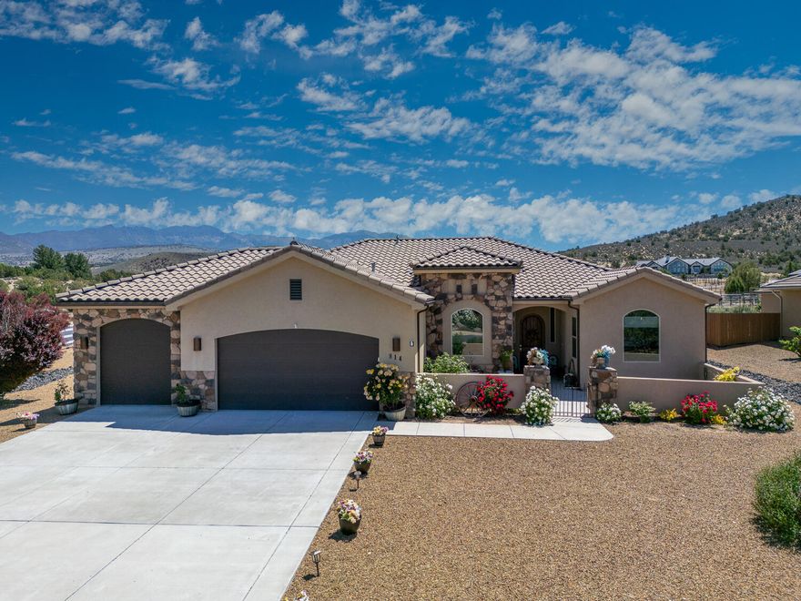 This 4 bedroom, 3 bath home in Dammeron Valley, Utah, is a captivating property that offers the perfect blend of comfort, versatility, and natural beauty. Set on nearly an acre of horse-zoned land, this stunning residence features a beautifully landscaped yard with native plants, a front Spanish courtyard, and a fenced backyard oasis, all peaceful outdoor spaces ideal for relaxing or entertaining. The home includes a second primary suite having potential to become a rentable casita with an extra attached room and separate entrance—perfect for generating income, housing guests, or creating a private retreat. Inside the main home, expansive windows frame breathtaking mountain views, flooding the open concept living spaces with natural light. The gourmet kitchen features deep granite countertops, under-cabinet lighting, a breakfast bar, walk-in pantry, and custom soft close cabinets.  Making your way to the main primary suite, enjoy private access to the covered back patio, an oversize bathroom with a large walk-in closet and built in shelves. The layout is thoughtfully designed for both everyday living and special gatherings, offering warmth, privacy, and elegance throughout.  Adding practical luxury, a fully finished three-car garage with a coated floor, built-in cabinets, dedicated AC, and wiring for a freezer or refrigerator.  Outside includes two sheds and the flat terrain provides ample room for equestrian use, with space to build corrals or stables. Whether you're looking for a peaceful escape, an investment opportunity, or a horse-friendly property with a view, this home delivers it all in one picturesque package.