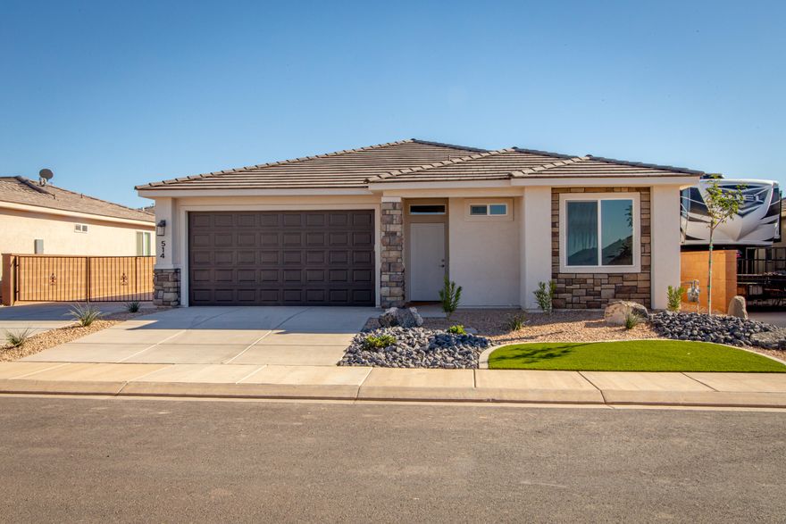 This Gemstone Custom Home is now finished and move-in ready! Featuring drought-tolerant professionally landscaped front and backyard with a covered patio, a master suite includes spacious walk-in closet and spa-like bath, and plenty of hardwood cabinetry in a spacious kitchen that opens directly into the main living space. Two car garage is fully drywalled and painted and at nearly 23'deep it can accommodate even very large pickup trucks. Quality GE appliances, stainless sink in the kitchen island, Moen Plumbing fixtures, quartz countertops, soft-close hinges and under-cabinet lights. Woodgrain tile floors and gas fireplace in living room. Thirty-foot paved RV pad with gates, water, 30-amp outlet and sewer dump!