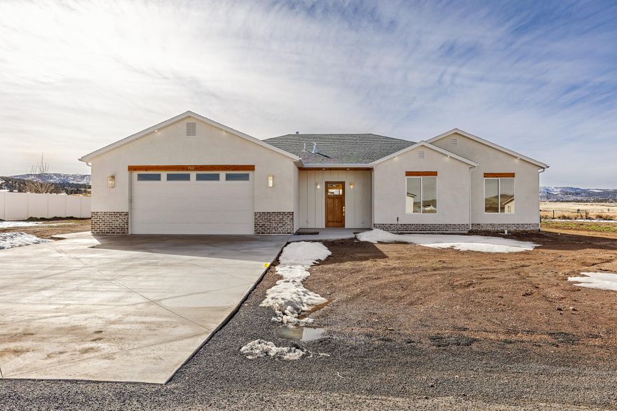 Brand new 2026 build in Enterprise! This 2,657 sq ft home offers 4 bedrooms, 3 full baths, and an oversized 2-car garage on a 0.50 acre lot. at the end of a cul-de-sac. No HOA. Designed with upgrades throughout: tall ceilings and doors, quartz countertops, custom cabinetry, large pantry, luxury laminate flooring, upgraded carpet/pad, and spray foam insulation for efficiency. The open living, dining, and kitchen area features an 8-burner ILVE gas range with electric oven, stunning hood, and a 6' side-by-side commercial-style fridge/freezer. Spacious primary suite with tiled shower and bath, plus a 2nd bedroom with private ensuite. Large laundry with sink, water softener, EV charger stub, shed/shop power stub, wired for sprinklers. Landscaping ready for your vision. 40 minutes to St. George or Cedar City.