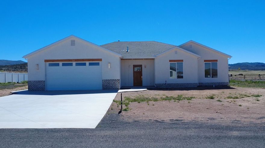 Brand new 2026 build in Enterprise! This 2,657 sq ft home offers 4 bedrooms, 3 full baths, and an oversized 2-car garage on a 0.50 acre lot. at the end of a cul-de-sac. No HOA. Designed with upgrades throughout: tall ceilings and doors, quartz countertops, custom cabinetry, large pantry, luxury laminate flooring, upgraded carpet/pad, and spray foam insulation for efficiency. The open living, dining, and kitchen area features an 8-burner ILVE gas range with electric oven, stunning hood, and a 6' side-by-side commercial-style fridge/freezer. Spacious primary suite with tiled shower and bath, plus a 2nd bedroom with private ensuite. Large laundry with sink, water softener, EV charger stub, shed/shop power stub, wired for sprinklers. Landscaping ready for your vision. 40 minutes to St. George or Cedar City.