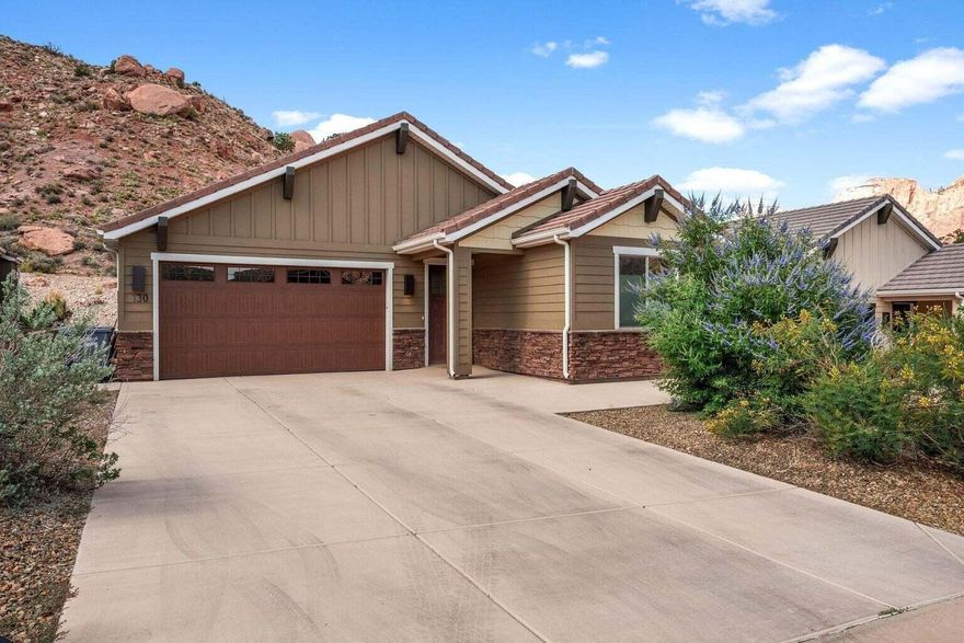 Discover an exceptional opportunity to own a beautiful 3bd 2ba single level home at the base of Zion National Park, perfectly positioned for both serenity and adventure. This property offers rare, protected backyard privacy with natural views that will remain preserved for generations.  Inside, the open-concept floor plan is designed for comfortable living and effortless entertaining.  Vaulted ceilings create a spacious, airy feel, while large windows invite in abundant natural light and frame the stunning surrounding landscape.  The seamless flow between the kitchen, dining, and split living spaces makes the home feel both expansive and inviting.  Step outside to a private sun deck and back yard covered patio that overlooks one of Americas most breathtaking national parks. With the park entrance just minutes away you are perfectly situated to enjoy world class hiking, biking, and outdoor recreation at a moments notice.  Whether you are seeking a full-time residence, a vacation retreat, or an investment in one of Southern Utahs most Iconic locations, this property offers location, privacy, and lifestyle in one remarkable package. Property like this doesn't come on the market very often, take advantage of this rare opportunity to own a home in Springdale.