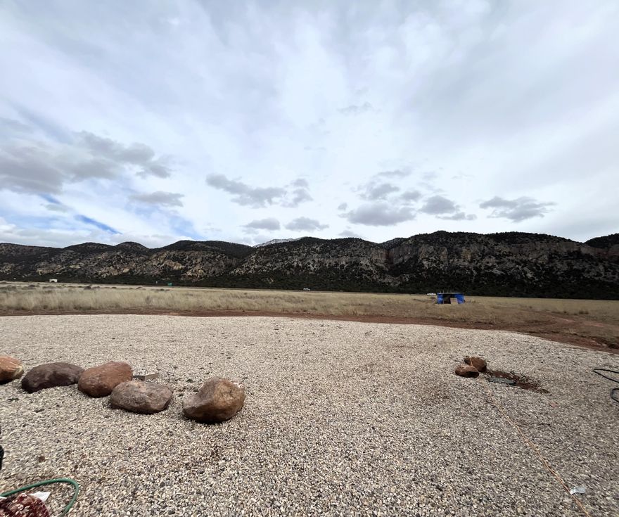 Don't miss this great opportunity to own 5.32 acres featuring sweeping views in every direction! This versatile property is ready to go, with power, water, and septic already connected and available on the lot making it ideal for building your dream home or getaway. Conveniently located between St. George and Cedar City, you're just about a 20 to 25 minute drive either way for shopping, dining, and entertainment, plus easy access to the freeway nearby. There's plenty of space to spread out and enjoy the wide-open surroundings and incredible views. Please note: All non-permanent structures on property NOT INCLUDED IN SALE.