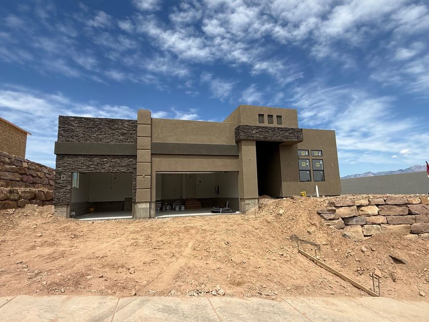 Views! Cascata at Divario is elevated above the city and Sunbrook Golf course. S&S Homes' 2123 floorplan is constructed of the finest materials by our master craftsmen. The open floor plan is great for gathering: gather around the cozy stone fireplace in the great room, or socialize around the stunning quartz island in the kitchen. A combination of painted and knotty alder cabinets enhance the open kitchen.  There are upgrades throughout.  Located just minutes from downtown, the freeway, Snow Canyon, and hiking trails.