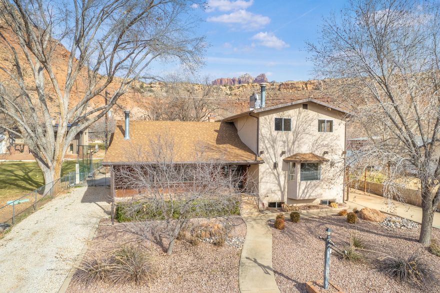 Rockville Homestead: .98 Acres of Opportunity Near Zion

Located on a lush, fully fenced .98-acre lot just minutes from the gates of Zion National Park, this estate offers a rare combination of space and self-sufficiency. The property is a productive homestead, featuring 1.5 shares of Rockville Town Ditch Company irrigation water with a clever hybrid system that utilizes both flood and pressurized lines for the garden and grounds. With horse privileges and a gravel parking area for trailers or equipment, this property is perfectly suited for a classic Southern Utah lifestyle.

The residence is a sturdy, light-filled sanctuary featuring six bedrooms and three-and-a-half bathrooms.While the home retains its original character, the essential infrastructure updates have been completed, including a new roof, new heating and cooling systems, and fresh carpet. The functional layout offers two separate family roomseach with a wood-burning fireplaceas well as a dedicated office and a creative craft area.

Practicality is found in every corner, from the abundant storage to the large laundry and mudroom that serves as a transition from the outdoors. The grounds are already optimized for small-town living, complete with a chicken coop and run, a storage shed with a workbench, and mature pecan, apple, and pear trees. This is a rare opportunity to secure a high-utility property in Rockville that is move-in ready today, while offering the "good bones" and water security needed to build significant equity as you customize it over time.